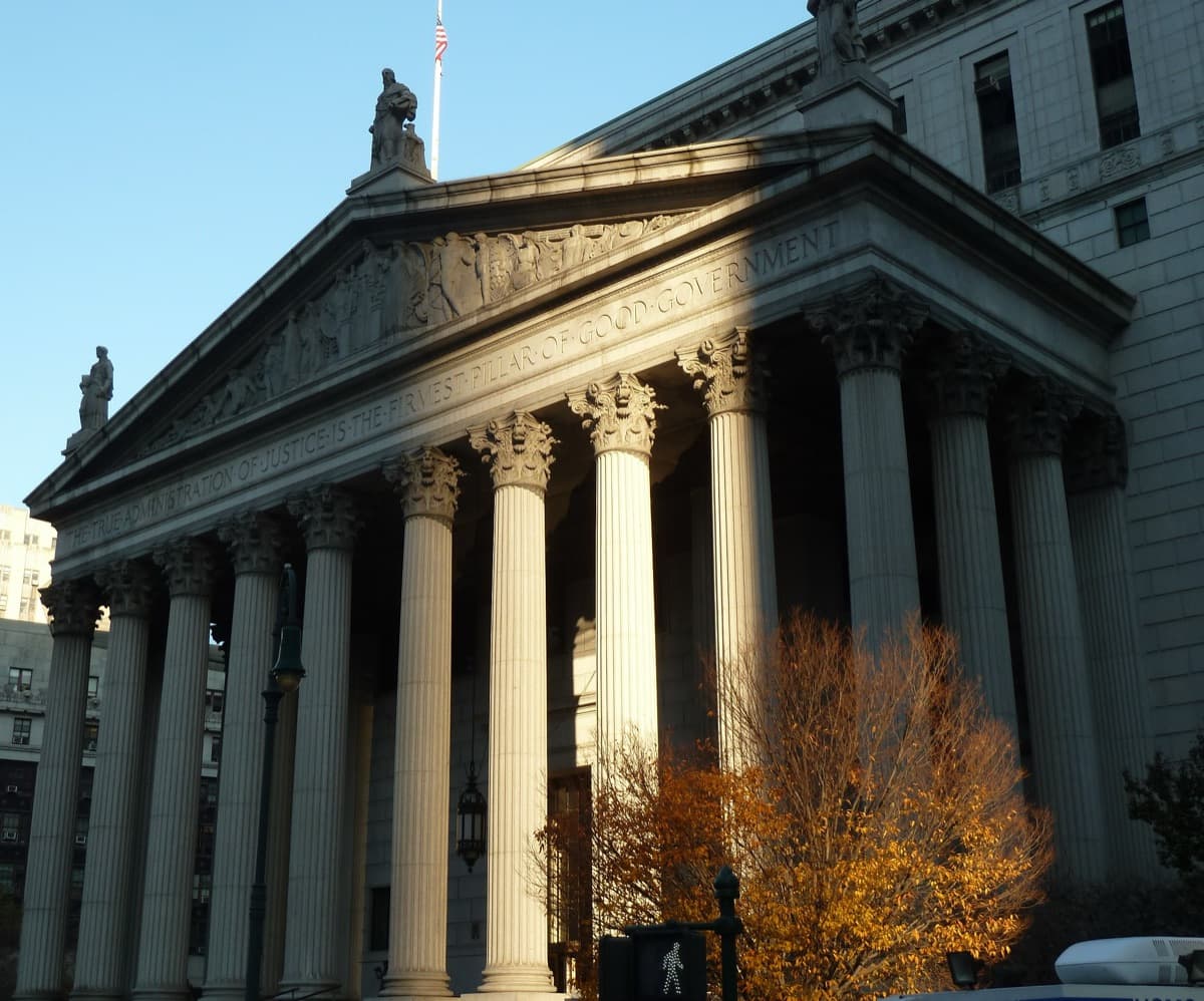 Colonnade of the New York County Supreme Court with the inscription 'The true administration of justice is the firmest pillar of good government'