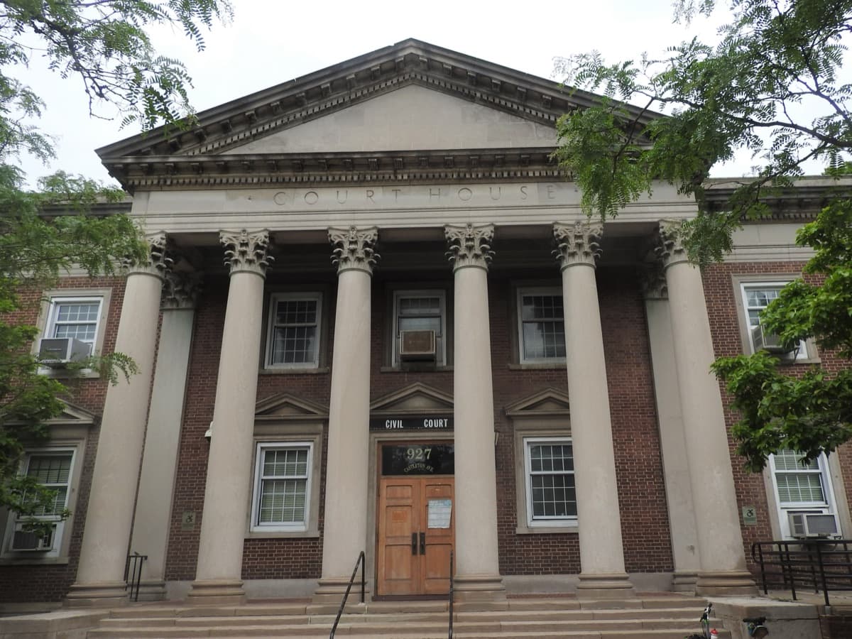 Close-up of a courthouse portico reading 'Court House' above Corinthian columns
